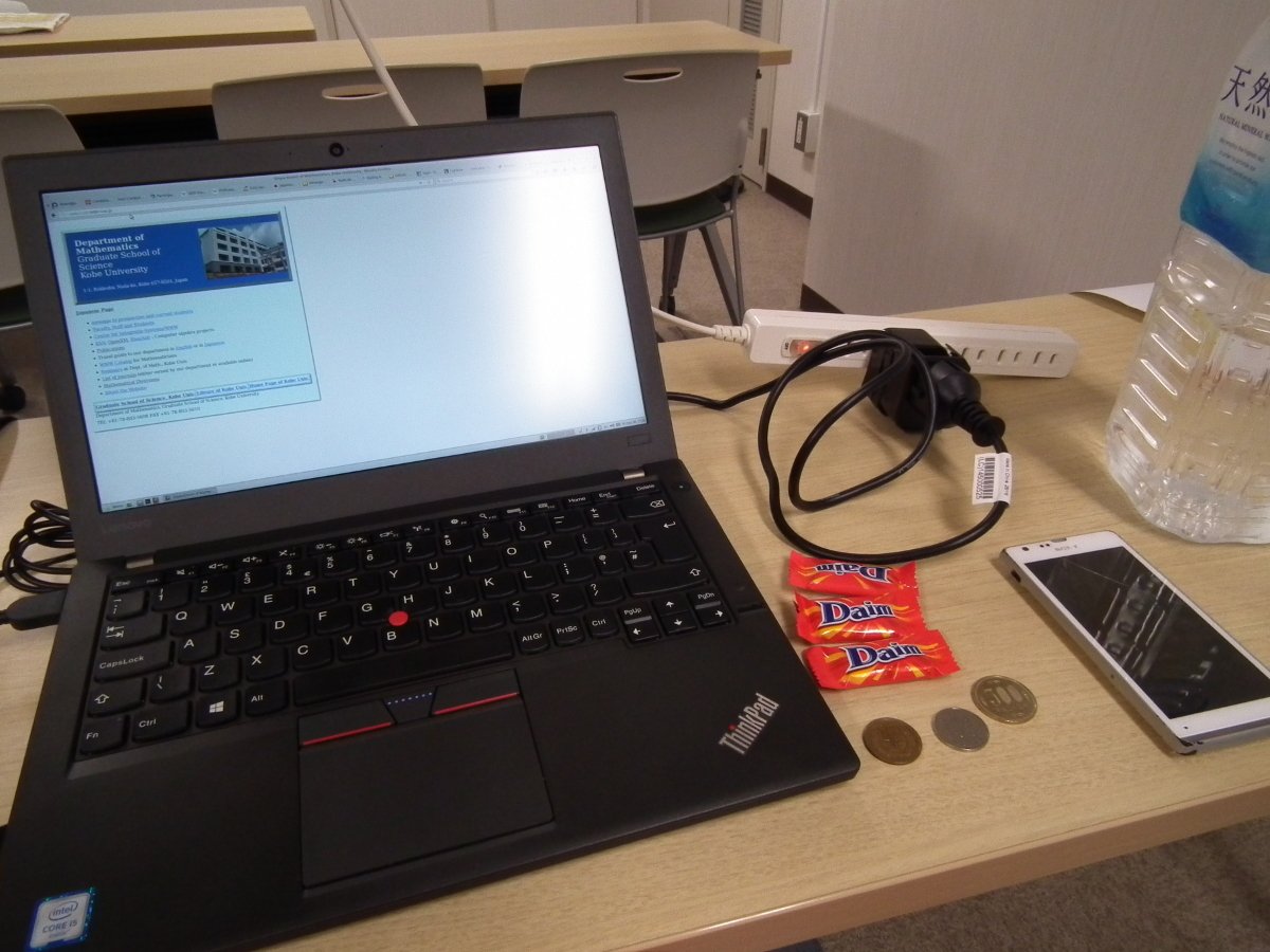 My laptop in Japan with Daim sweets, Japanese Yen and the power supply besides