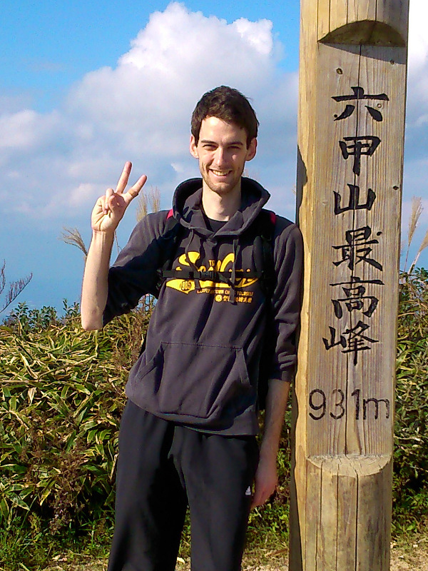 Lukas shown next to summit pole